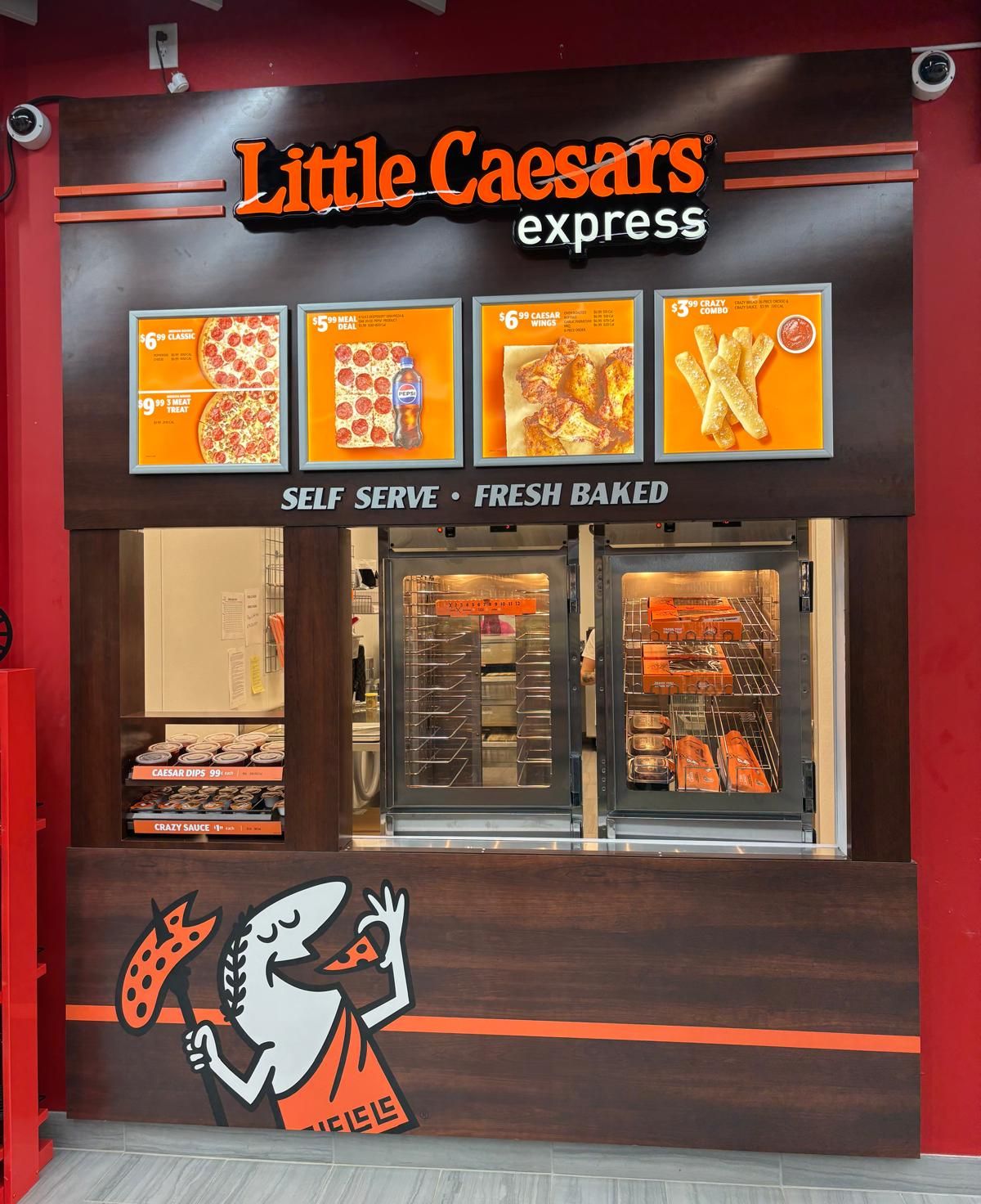 The Little Caesars Express counter: menu board over the self-serve warmer